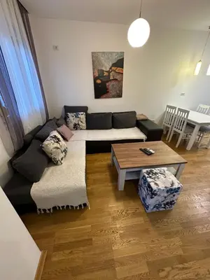 a living room with a couch and a table at Laura apartment City kvart in Podgorica