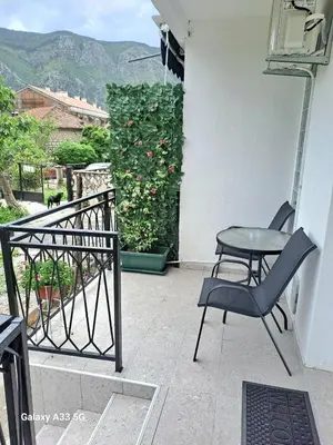 a patio with a chair and a table on a balcony at Apartment Marina 2 in Kotor