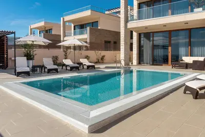 a swimming pool in front of a building at Villa Cape Montenegro on Cliffside in Kotor