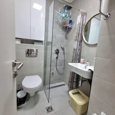 a bathroom with a shower and a toilet and a sink at Apartman Podgorica in Podgorica