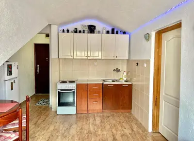 a kitchen with white cabinets and a purple light at Homestay Mark - DOUBLE BED ROOM - shared bathroom in Budva