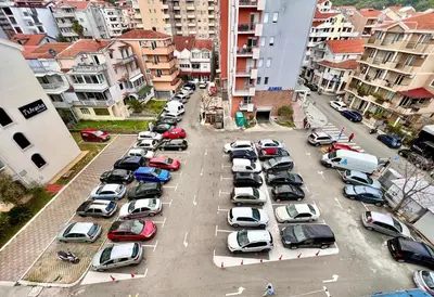 an aerial view of a parking lot with cars at Homestay Mark - DOUBLE BED ROOM - shared bathroom in Budva
