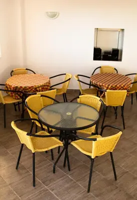 a group of tables and chairs in a room at Snežna Kraljica in Sutomore