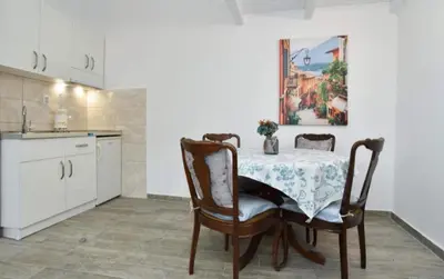 a kitchen with a table and chairs in a kitchen at Budva OLD TOWN 4 apartment in Budva