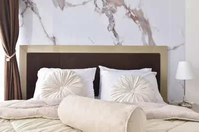 a bedroom with a large bed with white pillows at Apartment with 2 rooms in Tre canne hotel in Budva
