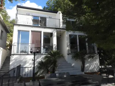 a white house with stairs and a balcony at Digital Nomads Camp in Bar, Susanj