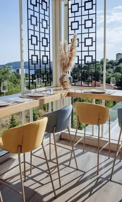 a table and chairs in a room with a window at Status-M Apartments 103 in Becici