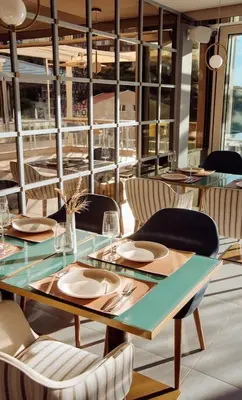a dining room with a table and chairs at Status-M Apartments 103 in Becici