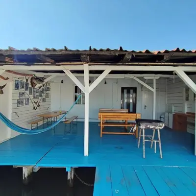 a porch with a bench and a slide on a boat at Kucica Truma in Ulcinj