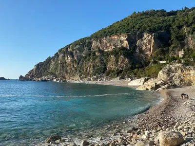 a beach with a rocky shore and the ocean at Casa Oliva Villa A with heating pool in Budva