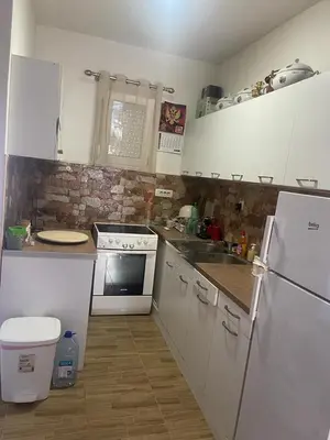 a kitchen with white appliances and a brick wall at Njegusi-Cetinje in Njeguši