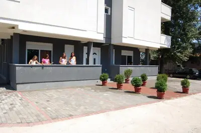 a group of women sitting on a balcony of a building at Apartmen Donji Stoj in Donji Štoj