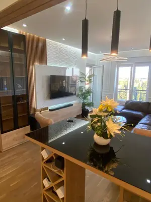 a living room with a table with flowers on it at Apartman Podgorica in Podgorica