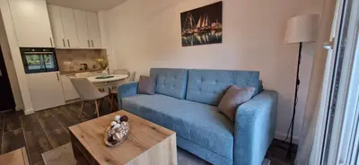 a living room with a blue couch and a table at Zira2 in Kotor