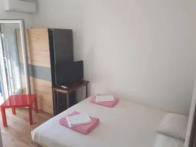 a small room with a bed and a television at Apartmani Dream 3 in Bar, Susanj