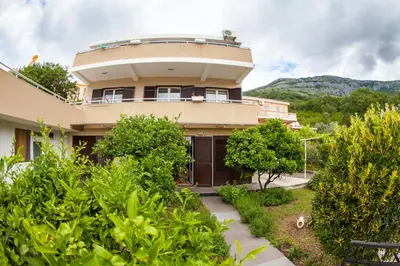 a house with a round building with a balcony at Apartments Vila Masha in Petrovac na Moru
