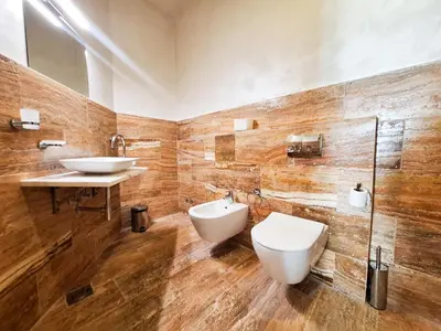 a bathroom with a toilet and a sink at Casa Oliva Villa with private heating pools in Budva