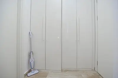 a room with four white closets with a whisk at Luxury apartment with 2 rooms in hotel Tre canne in Budva