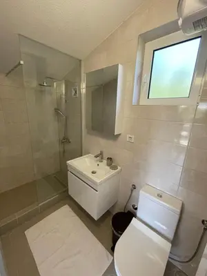 a bathroom with a white toilet and a sink at Grapefruit Home Apartment Ulcinj Montenegro in Donji Štoj