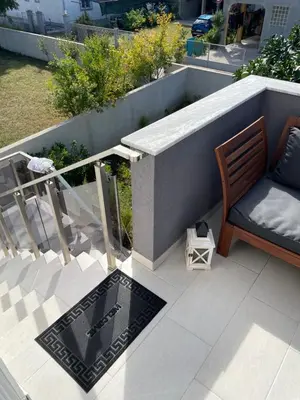 a patio with a bench and a table on a balcony at Grapefruit Home Apartment Ulcinj Montenegro in Donji Štoj