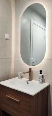 a bathroom with a sink and a mirror at Elegant Apartment with Urban Charm in Podgorica