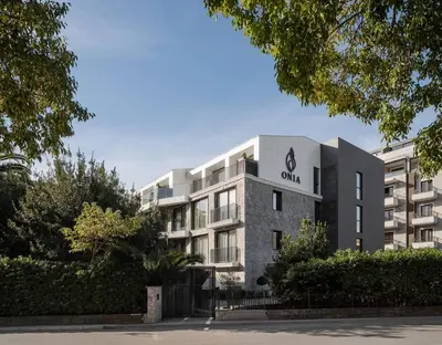an apartment building with a sign on the front of it at Two bedroom apartment Onia - Budva in Budva
