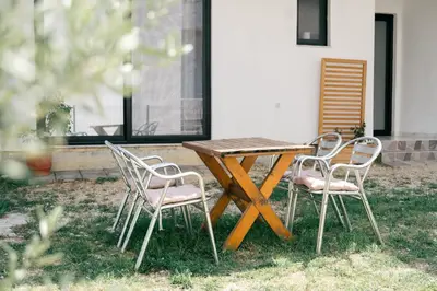 a wooden table and four chairs sitting around a table at You GO in Velika Plaža