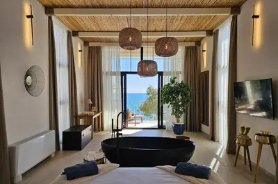 a bathroom with a large tub in the middle of a room at SeiSensi Luxury Beach Villa in Gornji Sušanj