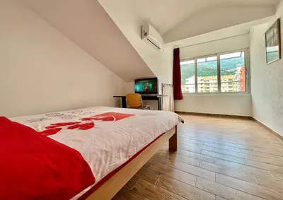 a bedroom with a large bed and a large window at Homestay LGBT friendly - DOUBLE BED ROOM in Budva