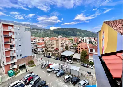 a city with cars parked in a parking lot at Homestay LGBT friendly - DOUBLE BED ROOM in Budva