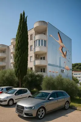 a group of cars parked in a parking lot in front of a building at Garsonjera Ulcinj in Ulcinj