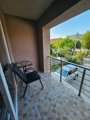 a balcony with a chair and a table and a view at Apartment Anita Cetinje 2 in Cetinje