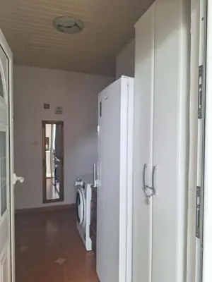 a kitchen with a white refrigerator in a room at Apartment at villa with pool in Budva