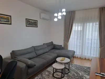 a living room with a couch and a table at Apartman Podgorica Vlado 1 in Podgorica