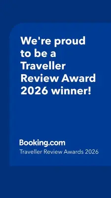 a blue sign that says were proud to be a traveller reviewagency winner at Matija Urban Suits- Downtown in Podgorica