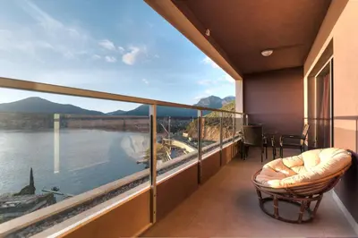 a balcony with a view of the water and mountains at Sea View Apartments MonteBook in Becici