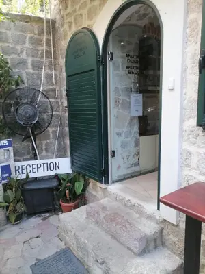 a green door on the side of a building at Apartments Bella in Kotor