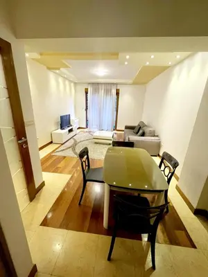 a living room with a table and a couch at City center apartment in Podgorica