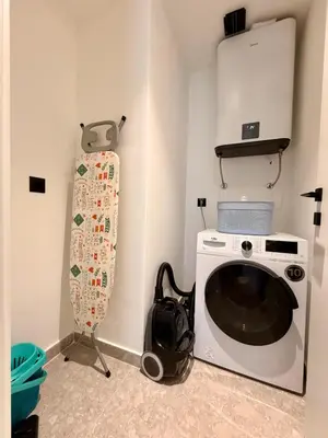 a washing machine in a room with a bag next to it at Air Onia in Budva