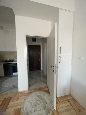 a room with a door leading into a kitchen at Studio 78 - Tuški put in Podgorica