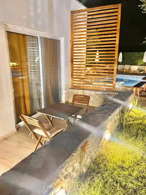 a patio with a table and chairs on a balcony at Eman Villas in Ulcinj