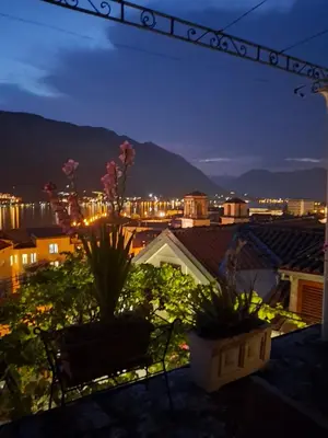 a view of a city from a balcony at night at Panoramic view ! Rooftop garden - Old Town studio in Kotor