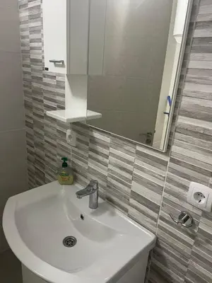 a bathroom with a white sink and a mirror at Leilighet i ulcinj in Ulcinj