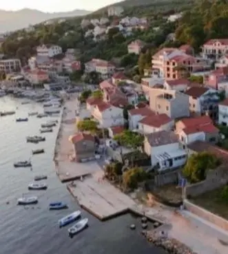 an aerial view of a town with boats in the water at Apartman sa sopstvenim dvoristem , pored mora in Bigovo
