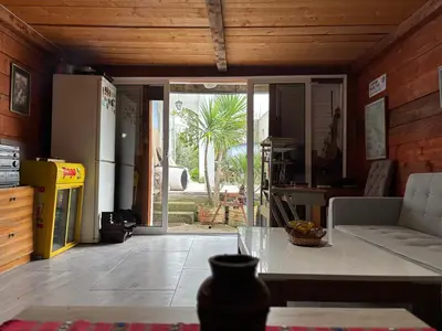 a kitchen with a refrigerator and a table in a room at Galicia Hills in Becici