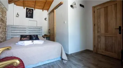 a bedroom with a bed and a wooden door at lifekotor in Kotor