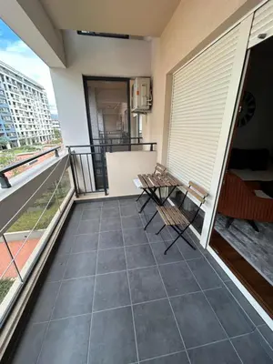 a balcony with chairs and a view of a building at Urban Apartment Master Quart in Podgorica
