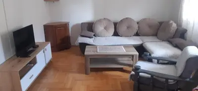 a living room with a couch and a table at Porodična kuća in Podgorica