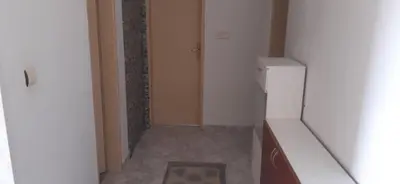 a hallway with a white refrigerator in a room at Porodična kuća in Podgorica