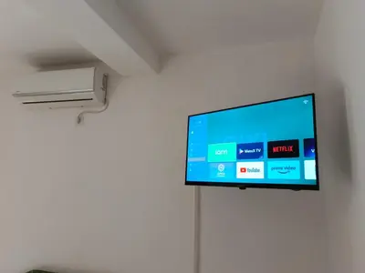 a flat screen tv hanging on a wall at Kolovic Susanj in Bar